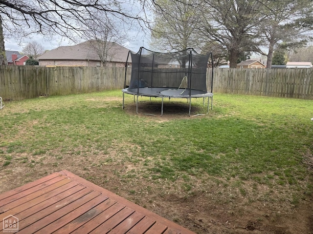 view of yard featuring a fenced backyard and a trampoline