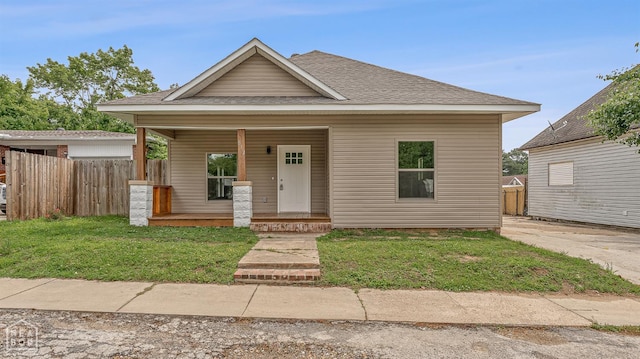 617 S 7th St, Paragould, AR 72450 - bungalow-style house with a porch and a shingled roof