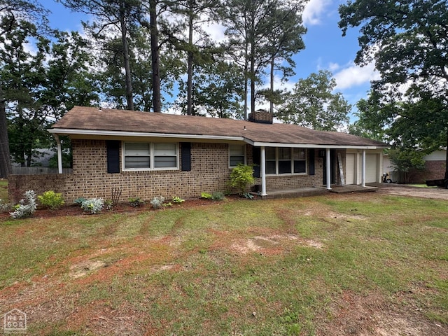 900 Sycamore Cv, Jonesboro, AR 72404 - single story home featuring brick siding, a garage, a front yard, and a chimney