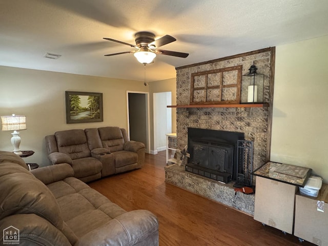 900 Sycamore Cv, Jonesboro, AR 72404 - living room featuring a ceiling fan, wood finished floors, and a fireplace