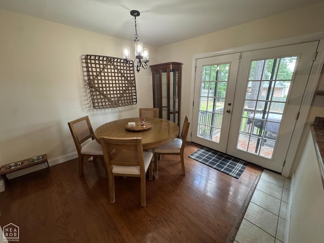 900 Sycamore Cv, Jonesboro, AR 72404 - dining area featuring a chandelier, wood finished floors, french doors, and baseboards