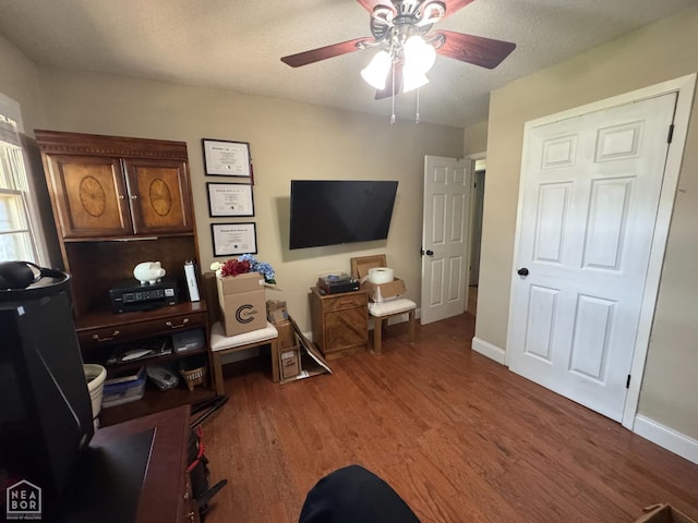 900 Sycamore Cv, Jonesboro, AR 72404 - sitting room featuring a ceiling fan, wood finished floors, baseboards, and an office area
