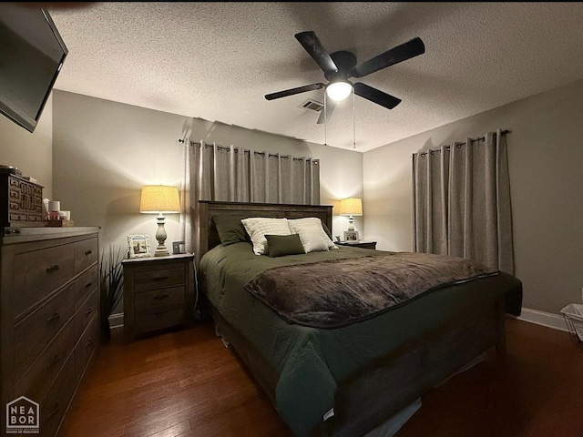 900 Sycamore Cv, Jonesboro, AR 72404 - bedroom with dark wood finished floors, a textured ceiling, ceiling fan, and baseboards