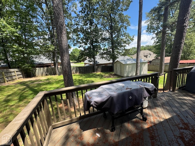 900 Sycamore Cv, Jonesboro, AR 72404 - wooden deck with a storage unit, an outdoor structure, and a grill