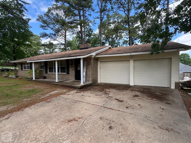 900 Sycamore Cv, Jonesboro, AR 72404 - single story home with an attached garage, driveway, brick siding, and covered porch