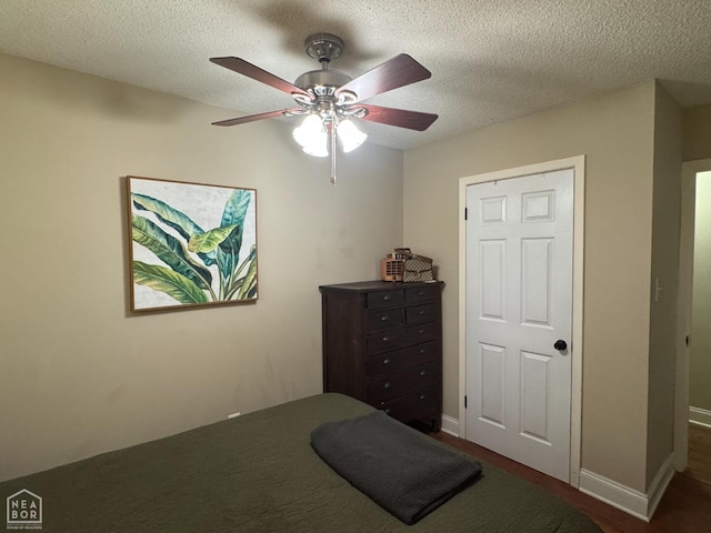 900 Sycamore Cv, Jonesboro, AR 72404 - bedroom with a ceiling fan, a textured ceiling, and baseboards