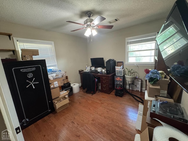 900 Sycamore Cv, Jonesboro, AR 72404 - office area featuring wood finished floors, ceiling fan, and a textured ceiling