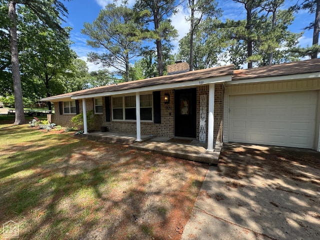 900 Sycamore Cv, Jonesboro, AR 72404 - ranch-style home featuring brick siding, a garage, a chimney, concrete driveway, and a porch