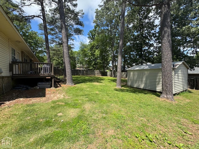 900 Sycamore Cv, Jonesboro, AR 72404 - view of yard featuring a wooden deck, a storage unit, and an outbuilding