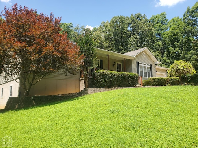2590 W N St, Piggott, AR 72454 - view of front of house featuring a front lawn and a garage