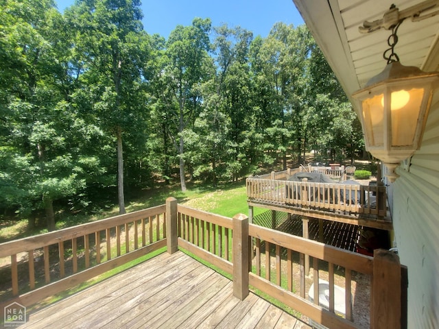 2590 W N St, Piggott, AR 72454 - wooden terrace featuring outdoor dining space and view of scattered trees