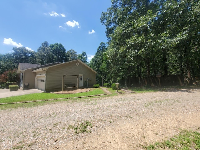 2590 W N St, Piggott, AR 72454 - view of property exterior with a garage and driveway