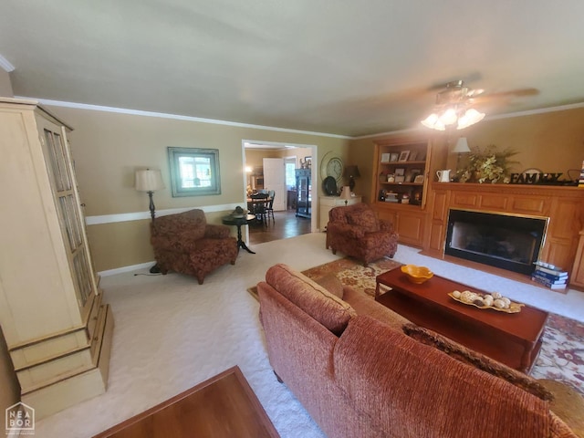 2590 W N St, Piggott, AR 72454 - carpeted living area with a fireplace, ornamental molding, and ceiling fan
