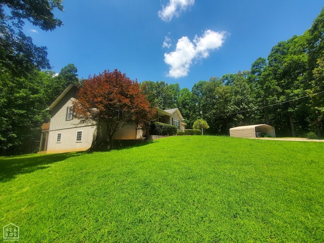 2590 W N St, Piggott, AR 72454 - view of grassy yard featuring a carport