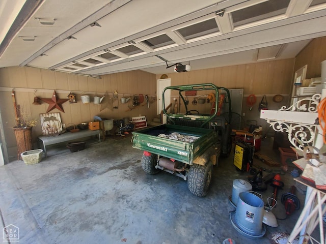 2590 W N St, Piggott, AR 72454 - garage with a garage door opener and wood walls