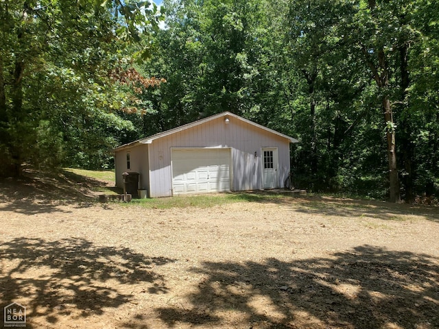 2590 W N St, Piggott, AR 72454 - view of outbuilding with driveway and a wooded view