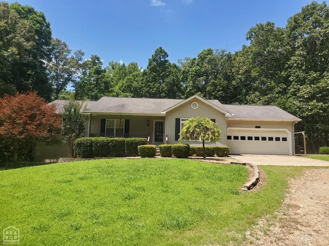 2590 W N St, Piggott, AR 72454 - single story home featuring concrete driveway, an attached garage, and a front yard