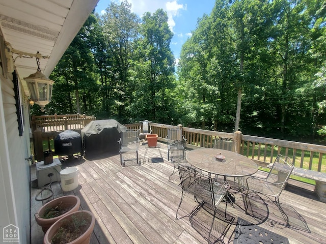 2590 W N St, Piggott, AR 72454 - wooden deck with outdoor dining space and a grill