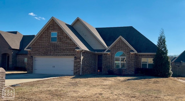 6509 Merrell Dr, Jonesboro, AR 72404 - view of front of home featuring brick siding, a garage, concrete driveway, and a front yard