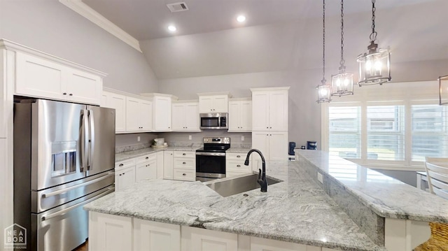 6509 Merrell Dr, Jonesboro, AR 72404 - kitchen with appliances with stainless steel finishes, a spacious island, white cabinetry, lofted ceiling, and light stone counters