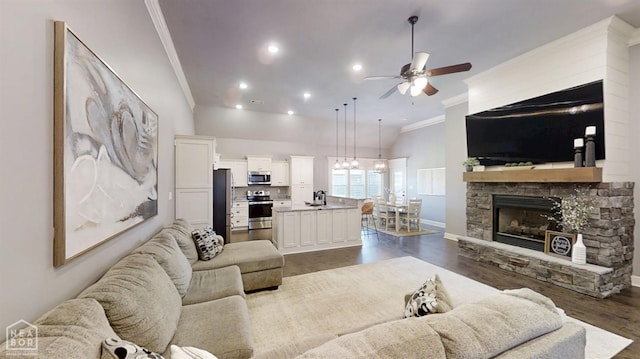 6509 Merrell Dr, Jonesboro, AR 72404 - living area with ornamental molding, ceiling fan, dark wood finished floors, a fireplace, and recessed lighting