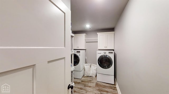 6509 Merrell Dr, Jonesboro, AR 72404 - washroom with separate washer and dryer, cabinet space, light wood finished floors, and baseboards