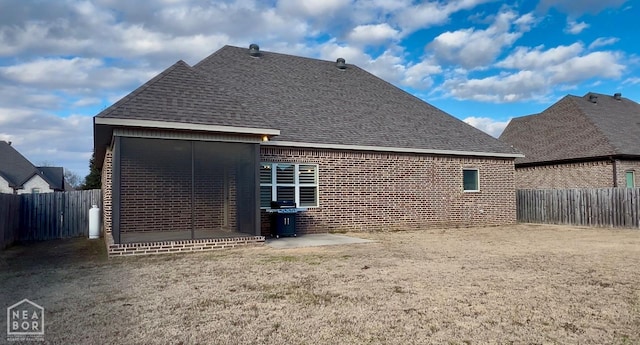 6509 Merrell Dr, Jonesboro, AR 72404 - rear view of property with a fenced backyard, brick siding, and a shingled roof