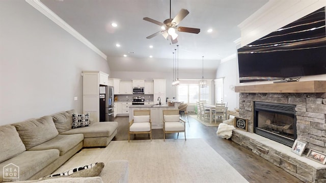 6509 Merrell Dr, Jonesboro, AR 72404 - living area featuring ornamental molding, a ceiling fan, wood finished floors, a fireplace, and recessed lighting