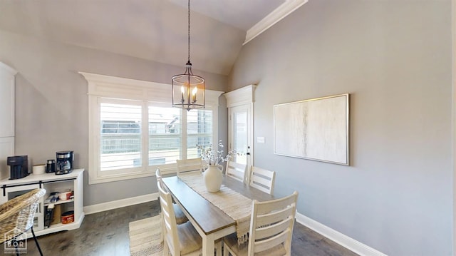 6509 Merrell Dr, Jonesboro, AR 72404 - dining space with vaulted ceiling, a chandelier, and dark wood-style flooring