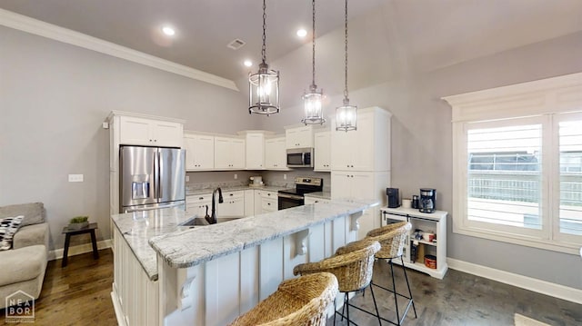 6509 Merrell Dr, Jonesboro, AR 72404 - kitchen with appliances with stainless steel finishes, white cabinets, light stone counters, a center island with sink, and a breakfast bar