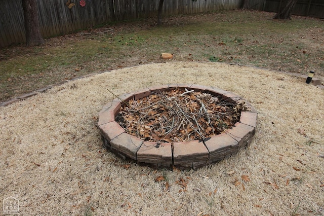 details with a fire pit and fence