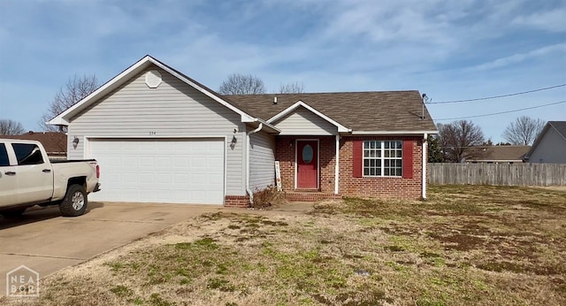 334 Linda St, Bono, AR 72416 - single story home featuring roof with shingles, fence, brick siding, an attached garage, and driveway