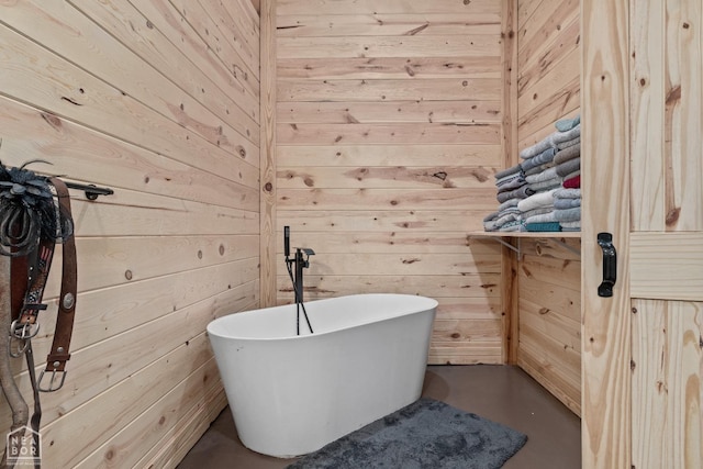 bathroom featuring a soaking tub and wood walls