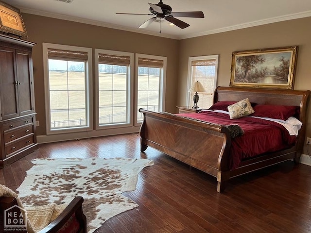 bedroom featuring dark wood-type flooring, multiple windows, and ornamental molding