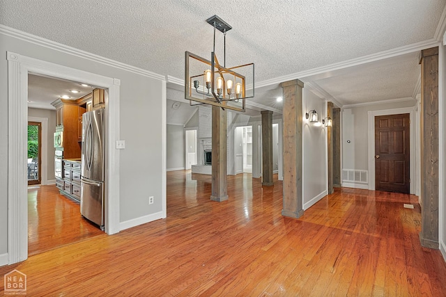 2203 Rankin Cir, Jonesboro, AR 72404 - unfurnished dining area featuring light wood finished floors, crown molding, a chandelier, baseboards, and a textured ceiling