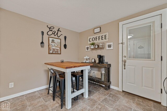 215 N Nance St, Monette, AR 72447 - dining space featuring baseboards and stone finish flooring