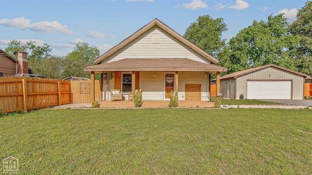 215 N Nance St, Monette, AR 72447 - view of front of home featuring a garage, a porch, and an outbuilding