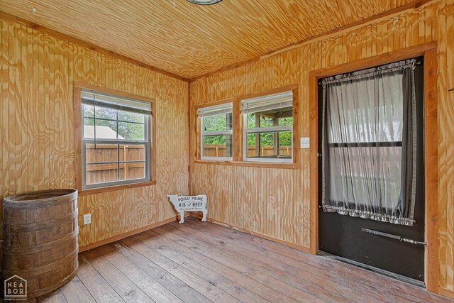 215 N Nance St, Monette, AR 72447 - unfurnished room with hardwood / wood-style flooring, wood walls, crown molding, baseboards, and wooden ceiling