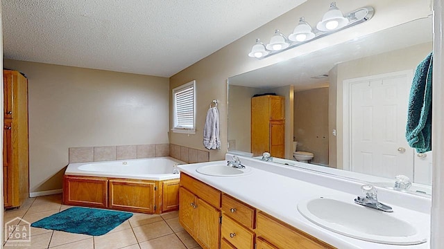 2316 Sheffield Dr, Jonesboro, AR 72405 - bathroom featuring a bath, a textured ceiling, tile patterned floors, toilet, and double vanity