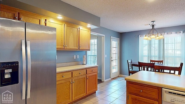 2316 Sheffield Dr, Jonesboro, AR 72405 - kitchen featuring stainless steel fridge with ice dispenser, dishwasher, light countertops, light tile patterned floors, and hanging light fixtures