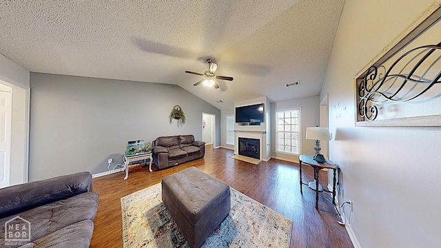 2316 Sheffield Dr, Jonesboro, AR 72405 - living area with a ceiling fan, a fireplace with flush hearth, wood finished floors, vaulted ceiling, and baseboards