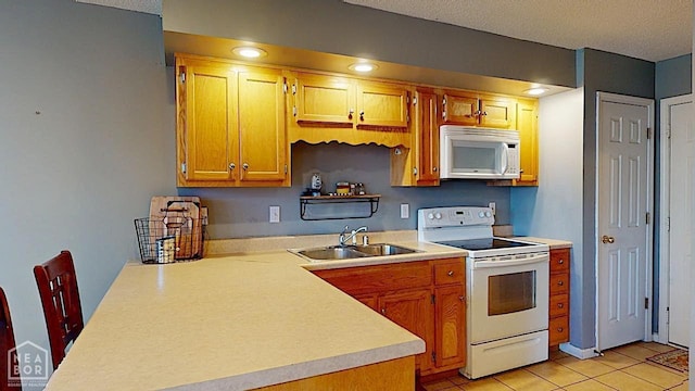 2316 Sheffield Dr, Jonesboro, AR 72405 - kitchen with white appliances, a sink, light countertops, light tile patterned floors, and a textured ceiling