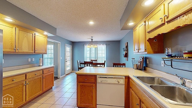 2316 Sheffield Dr, Jonesboro, AR 72405 - kitchen featuring white dishwasher, a peninsula, a sink, a textured ceiling, and light countertops