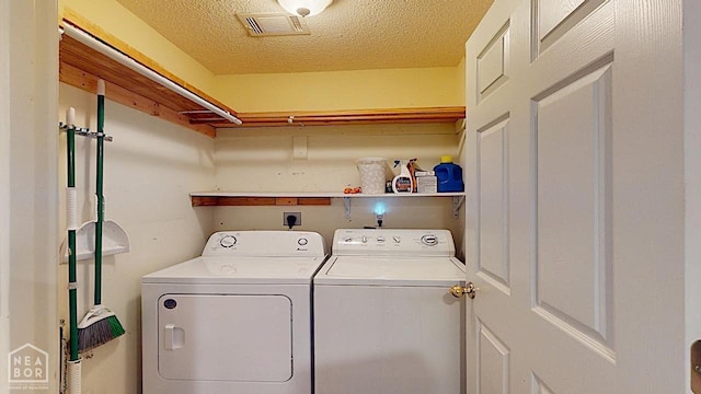 2316 Sheffield Dr, Jonesboro, AR 72405 - laundry room featuring washing machine and dryer and a textured ceiling