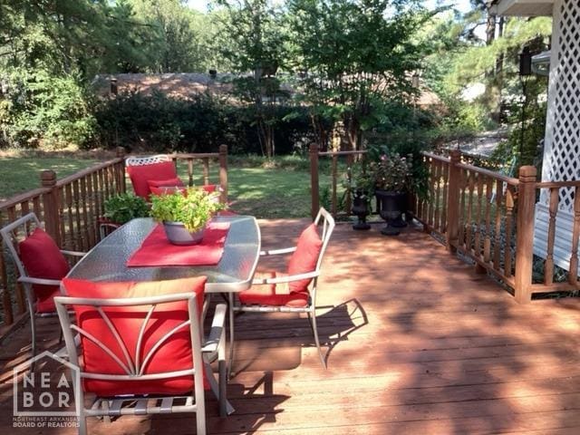 wooden deck featuring outdoor dining area