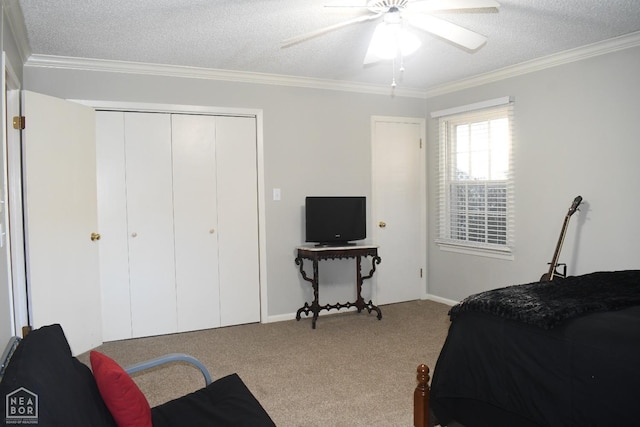 carpeted bedroom with a textured ceiling, a closet, and crown molding