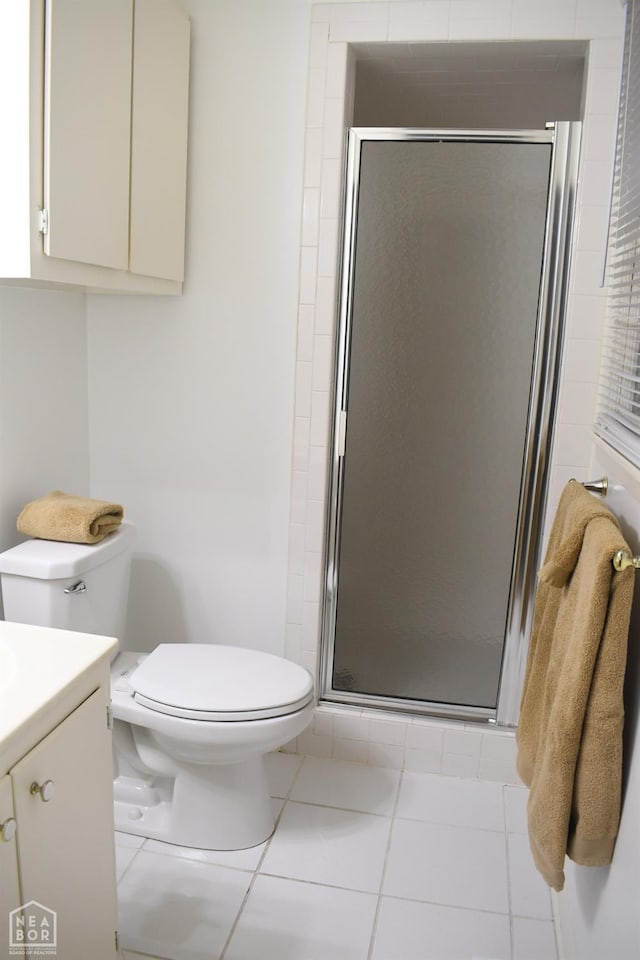 full bath with a shower stall, tile patterned floors, vanity, and toilet