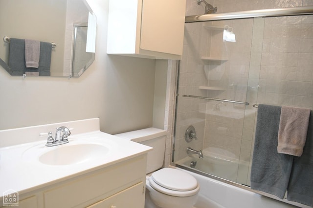 full bath featuring shower / bath combination with glass door, vanity, and toilet