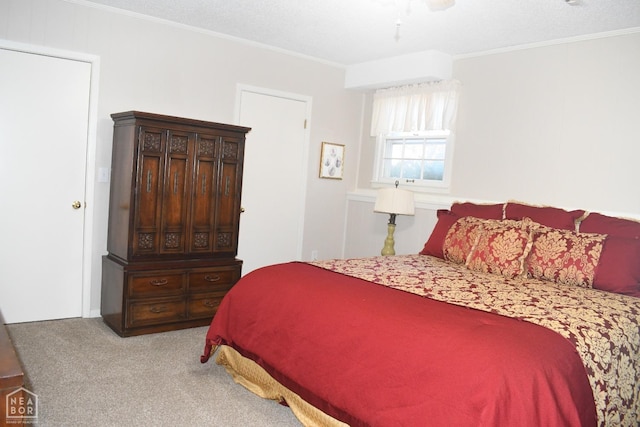 carpeted bedroom featuring ceiling fan and ornamental molding