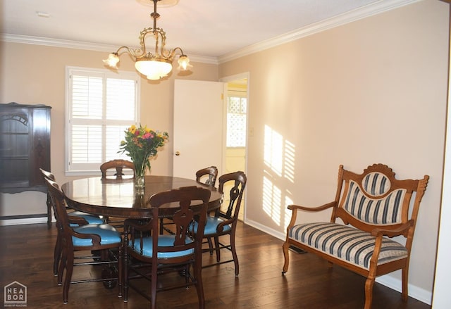 dining room with dark wood-style flooring, ornamental molding, baseboards, and an inviting chandelier